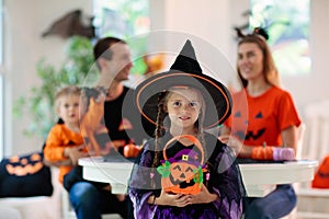 Family carving pumpkin. Halloween trick or treat