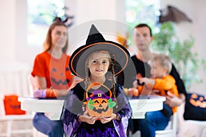 Family carving pumpkin. Halloween trick or treat