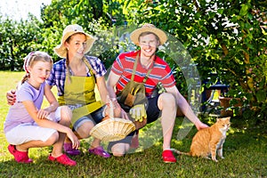 Family with cat gardening in garden