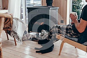 Family with cat relaxing by the fire place