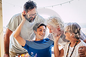 Family caucasian portrait of happy cheerful family with three generations from grandson to son and grandfathers all together photo