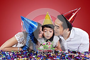 Family celebrate birthday with red background