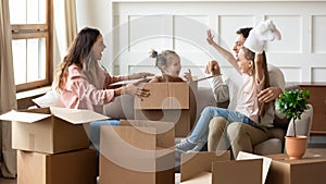 Family celebrate relocation day playing with little kids feeling happiness