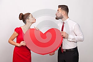 Family celebrate valentine`s day, sending each other air kiss