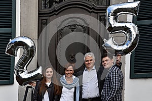 Family celebrating the 25th marriage anniversary of the parents