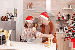 Family celebrating christmas holiday preparing homemade dough dessert