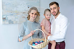 Family celebrating Easter with painted eggs
