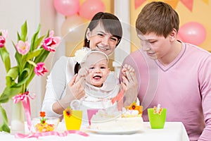 Family celebrating first birthday of baby girl