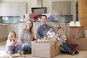 Family Celebrating Moving Into New Home With Pizza