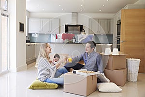 Family Celebrating Moving Into New Home With Pizza