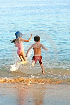 Family chase into warm sea photo