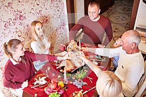 Family cheering and drinking on Thanksgiving on a blurred background. Family holiday gathering concept.