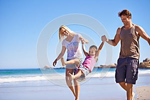 Family, child and fun by swinging on beach, love and trust or travel on summer holiday. Happy parents, daughter and