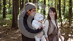 Family with child go in autumn park