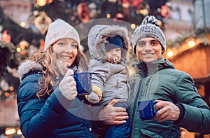 Family with child having fun at the Christmas market