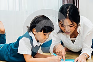 Family child kid boy son kindergarten and beautiful mother education teaching drawing together