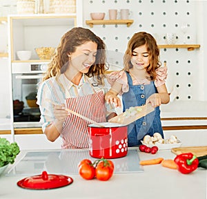 family child kitchen food daughter mother father cooking preparing breakfast happy together