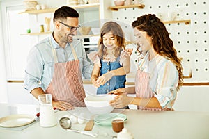 family child kitchen food daughter mother father cooking preparing pancake breakfast happy together