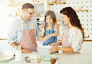 family child kitchen food daughter mother father cooking preparing pancake breakfast happy together