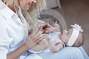 Family, child and motherhood concept - happy smiling mother with little baby daughter at home