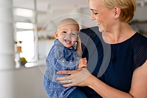 Family, child and parenthood concept. Happy smiling young mother with little baby at home