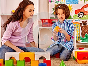 Family with child playing bricks