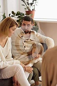 Family with a child at a psychotherapist at the reception