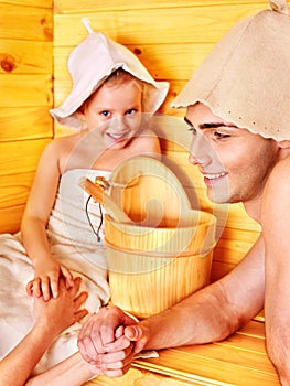 Family with child relaxing at sauna.
