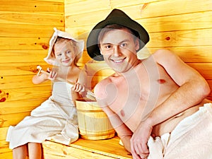 Family with child relaxing at sauna.