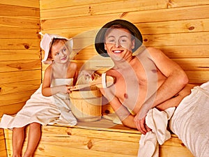 Family with child relaxing at sauna