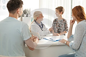 Family with child visiting doctor