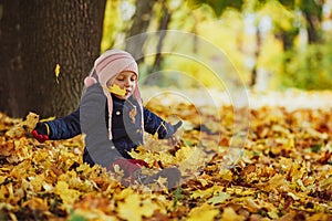 Family, childhood,fall season and people concept, happy girl playing with autumn leaves in park.little child, baby girl