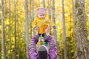 Family, childhood, fatherhood, leisure and people concept - happy father and little son playing outdoors