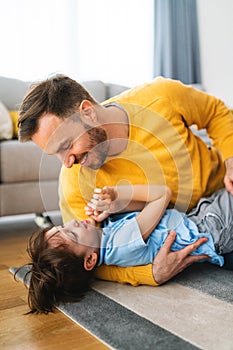 Family, childhood, single parent concept. Happy father and little son having fun together at home