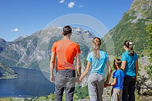 Family with children above Geiranger Fjord.