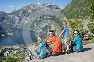 Family with children above Geiranger Fjord.