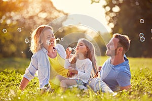 Family with children blow soap bubbles