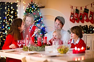 Family with children at Christmas dinner at home
