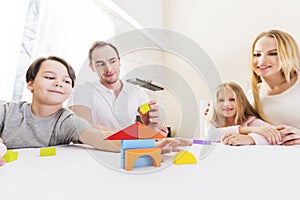 Family with children constructing house