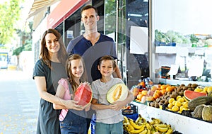 Family with children demostration fresh fruits photo