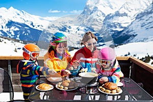 Family apres ski lunch in mountains. Skiing fun photo