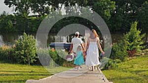 Family with children going to have a picnic and have fun together