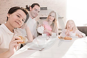 Family with children having breakfast