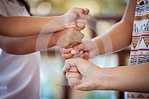 Family and children holding hands together