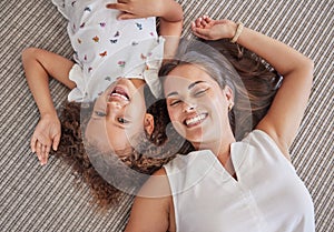 Family, children and love above a girl and mother lying on a bed in the bedroom of their home together from above. Kids