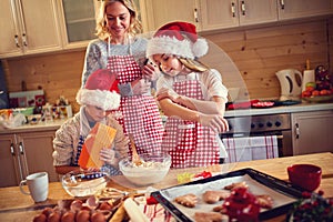 Family of children and mother baking cookies at home