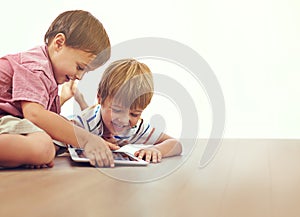 Family, children and siblings with tablet on a floor for cartoon, gaming or streaming movie at home. Digital, learning