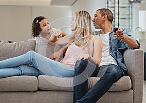 Family, children and watching tv with a mother, daughter and father in the living room of their home together. Sofa