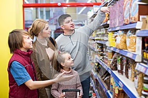 Family choosing cereal in supermarket