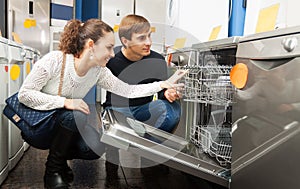 Family choosing new dish washing machine